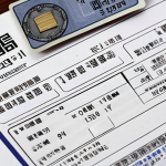 A close-up shot of essential documents for a real estate contract. Key items include an ID card (partially blurred for privacy), a neatly stamped contract with a traditional Korean 도장 (stamp), and a financial document highlighting the 계약금 (down payment). The overall feel is organized and reassuring, suggesting careful preparation for a successful home purchase.